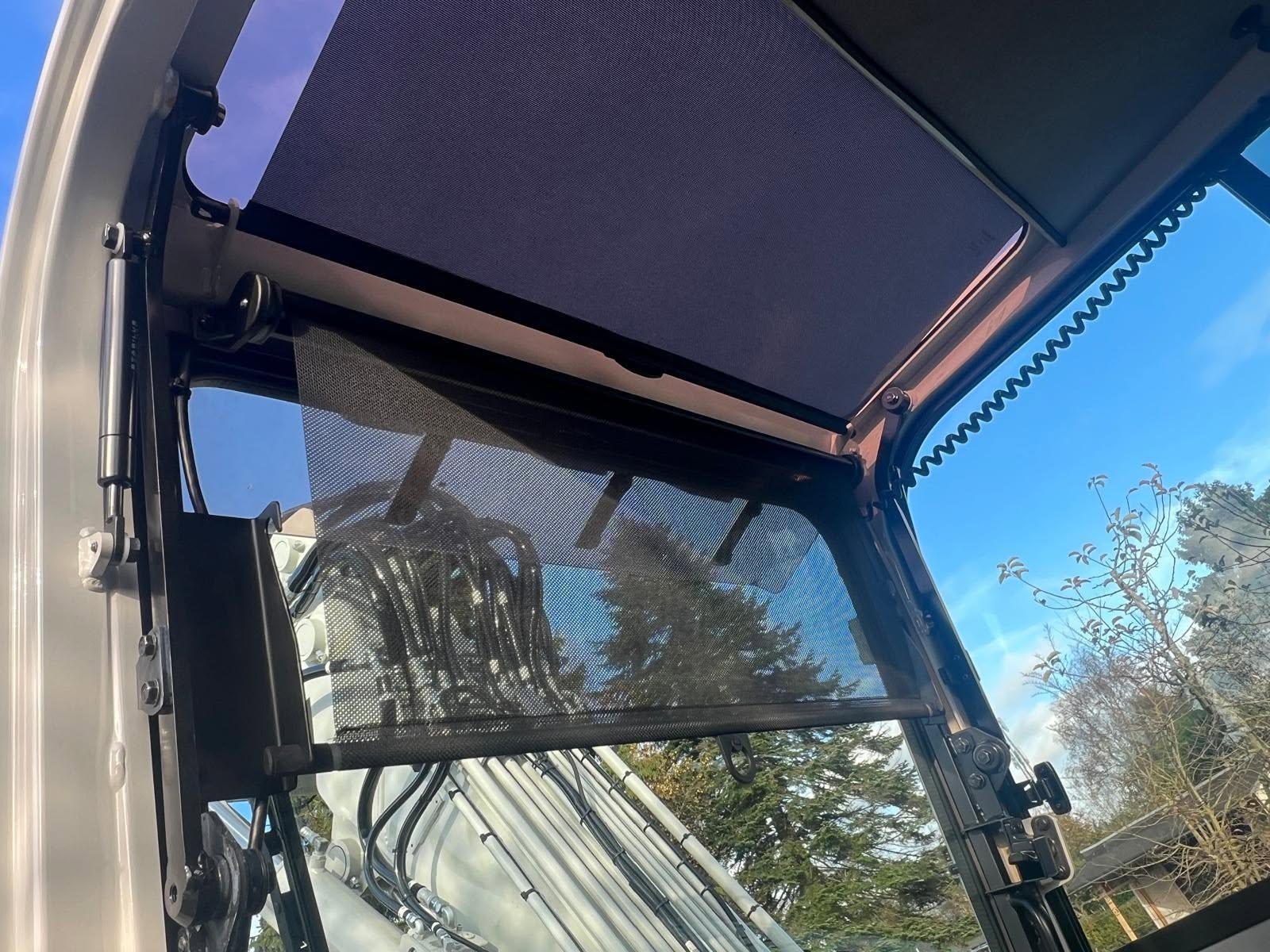 Blinderingen in de cabine van een Takeuchi graafmachine