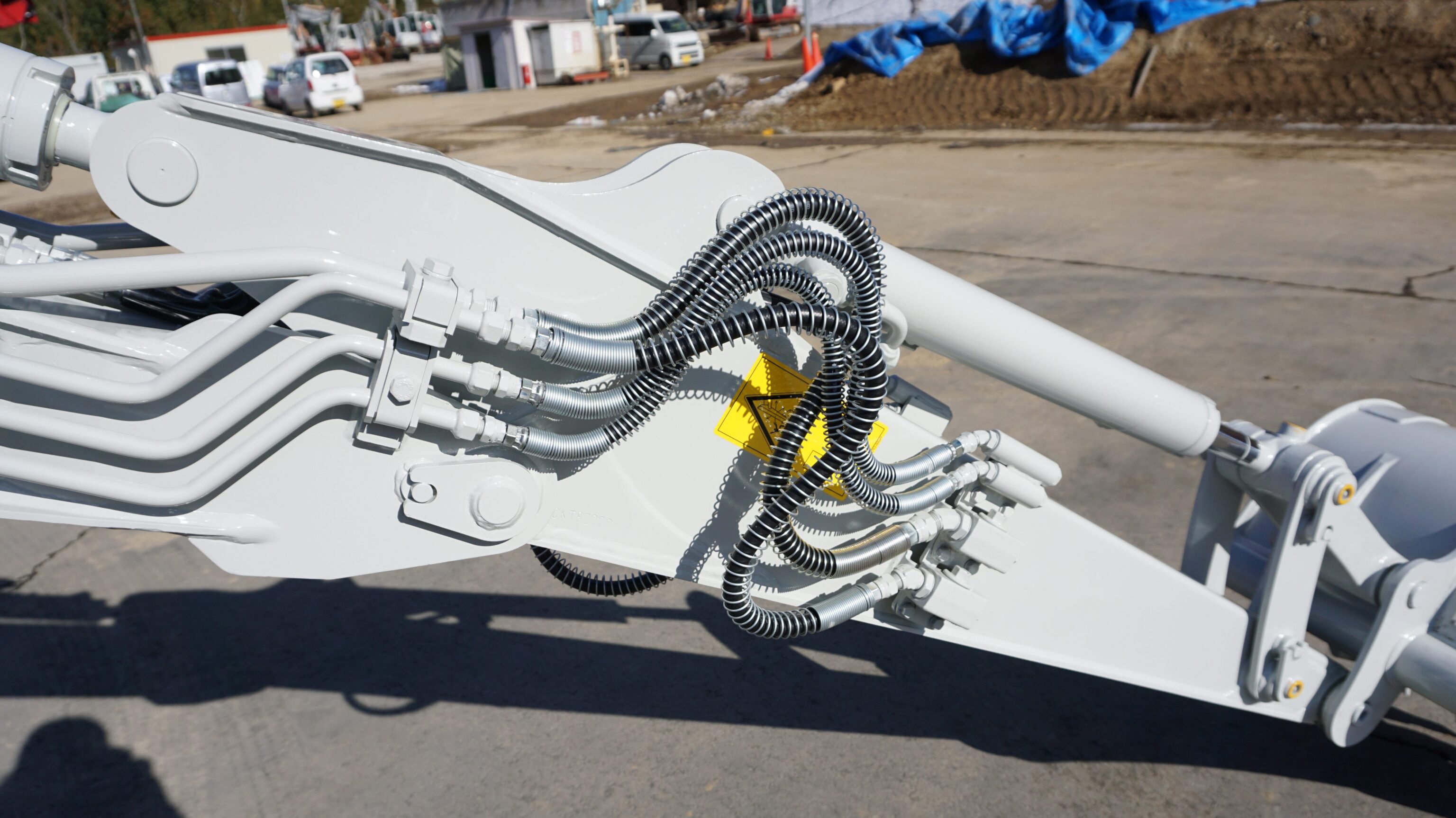Hydrauliek op de giek van een Takeuchi graafmachine