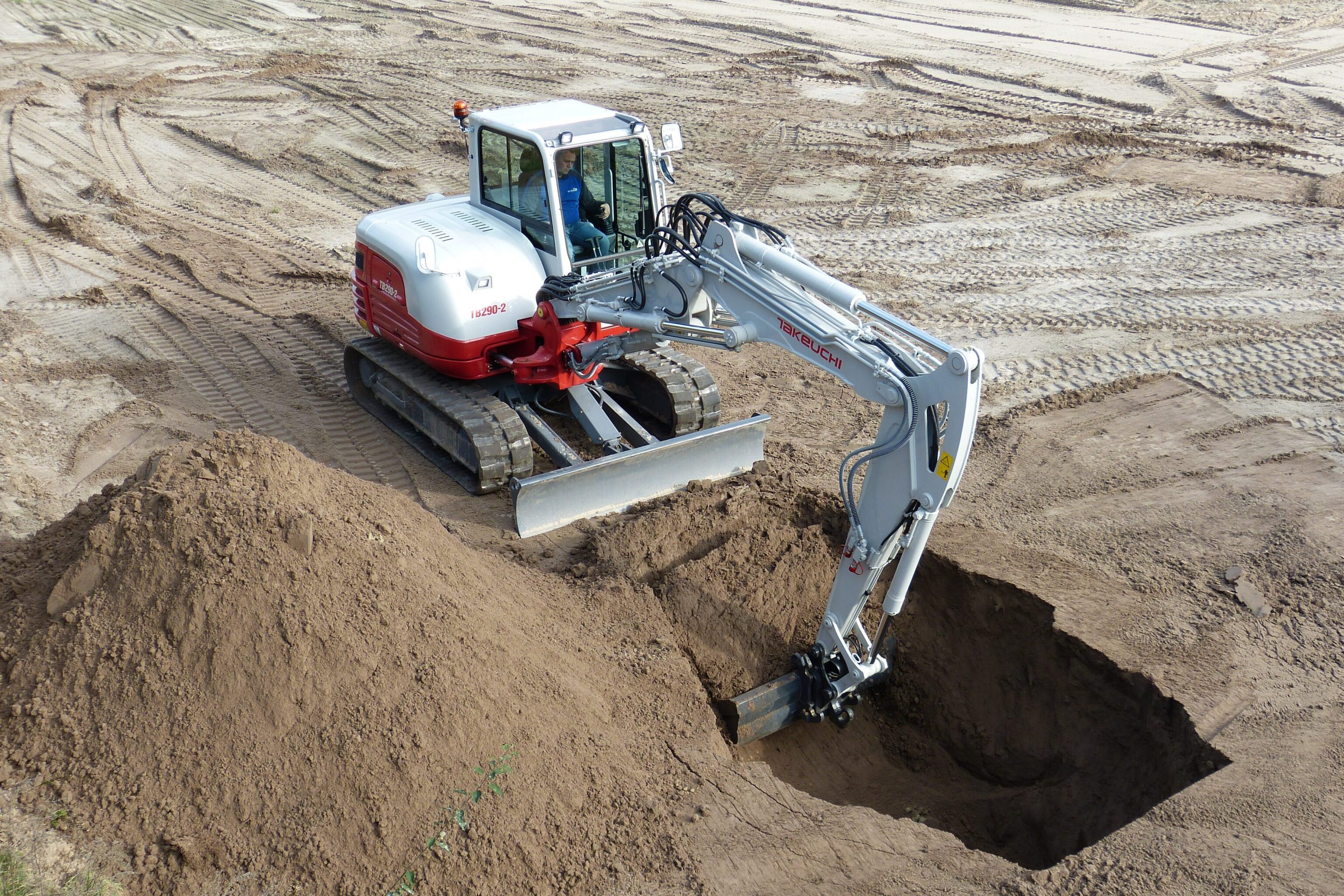 Takeuchi TB290-2 two piece boom graaft een diepe kuil